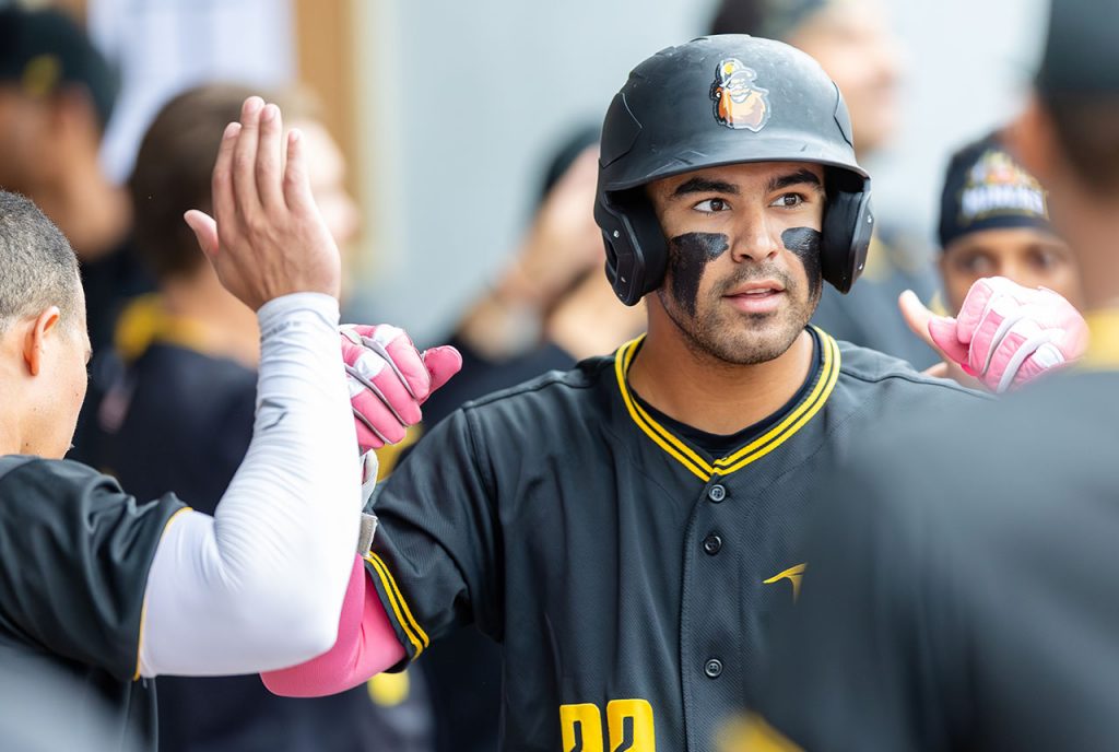 Infielder Kiko Romero celebrates with teammates after his two-run home run (photo by Phil Hoops).