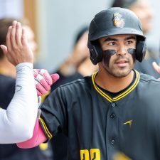Infielder Kiko Romero celebrates with teammates after his two-run home run (photo by Phil Hoops).