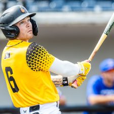 Sussex County Miners shortstop Evan Berkey hits in the gold jersey (photo by Phil Hoops).